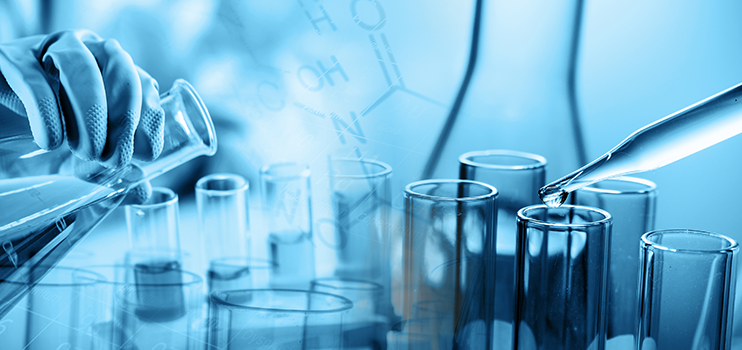 hand of scientist holding flask with lab glassware in chemical laboratory background with the entire image tinted in blue