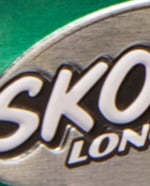 Partial image of a Skoal can in green and silver.