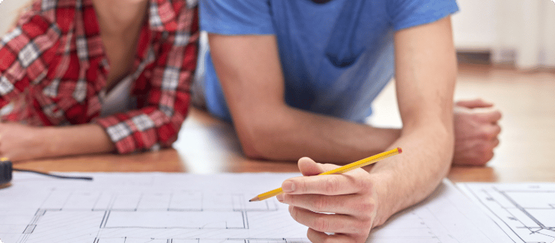 A couple reviewing them home's blueprints.