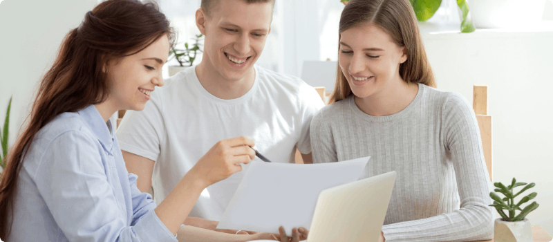 An insurance agent reviewing documents with her clients.