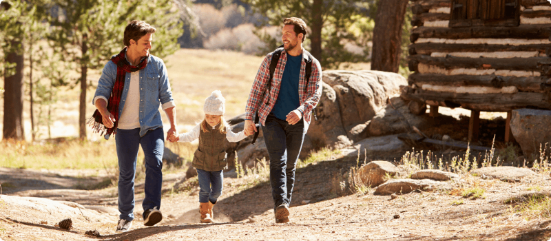 Couple walking with their child in the mountains. 
