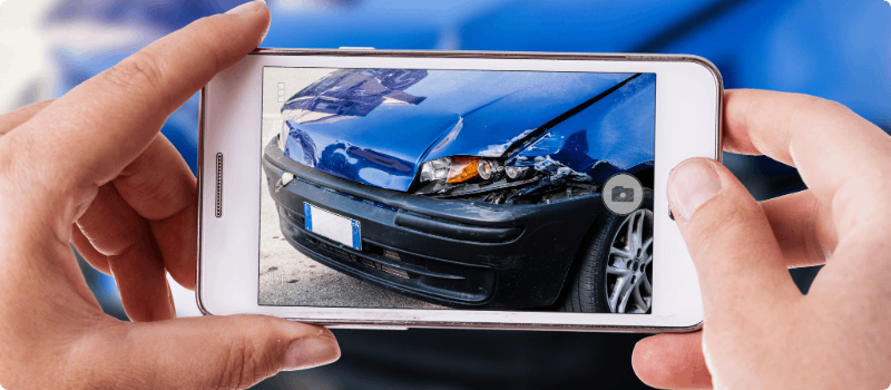 Person taking a photo of an auto accident.