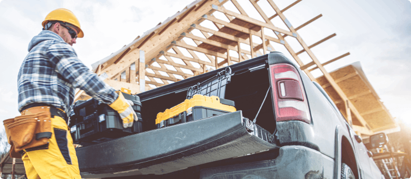 A contractor removing tools from his truck.