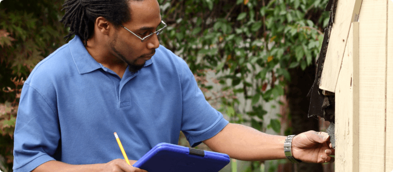 A home inspector evaluating a roof.