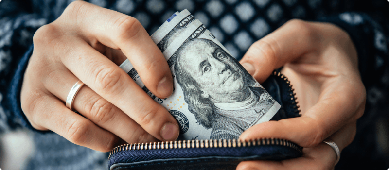 A person pulling money from her wallet.