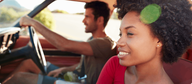 Happy couple going for a drive on a sunny day. 