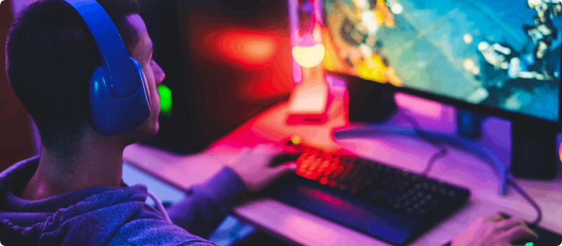 Person playing games on his computer. 