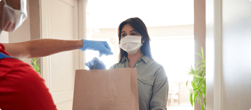 Person delivering food to another person.