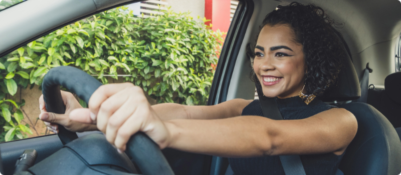 A happy person driving.