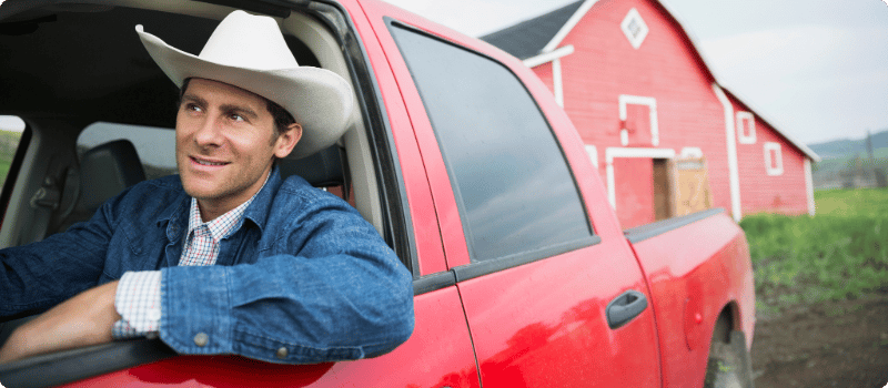 A smiling person in a truck. 