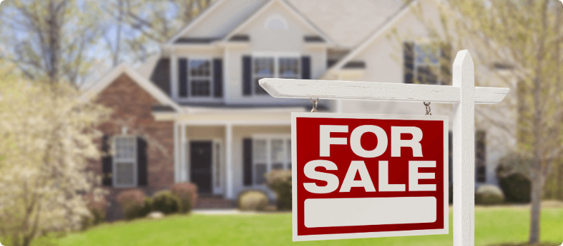Home with a For Sale sign in the yard.