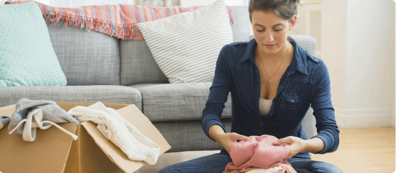 Person folding and packing clothing.