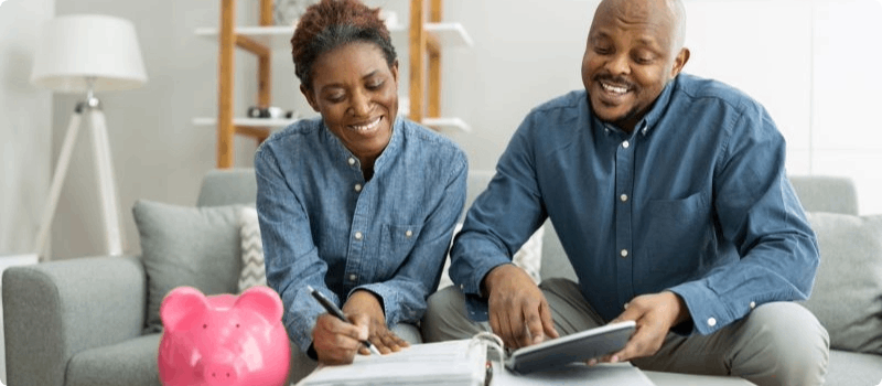 Happy couple budgeting their bills. 