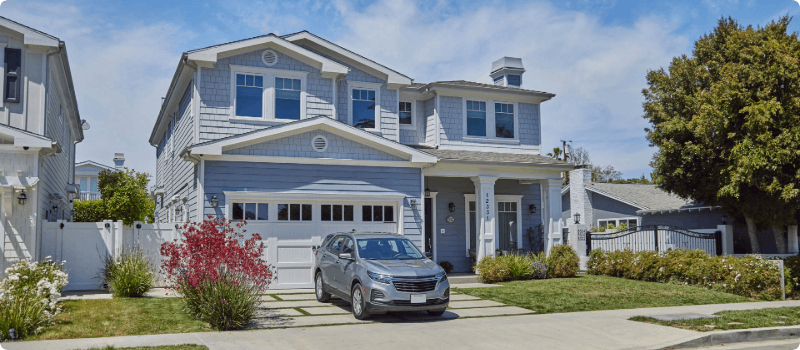 A nice house with a car in the driveway. 
