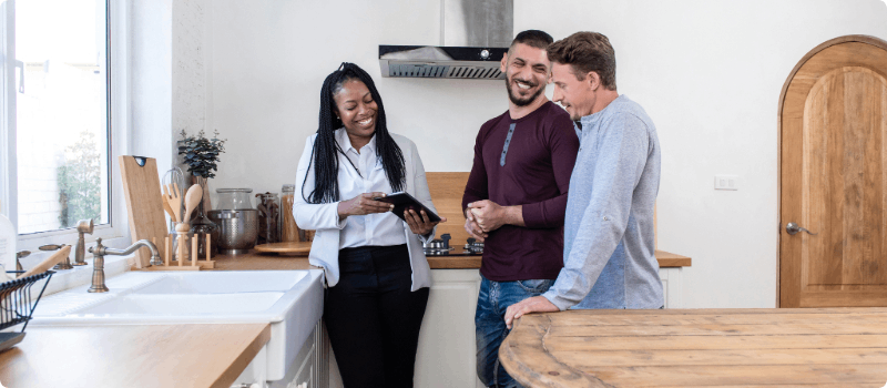 Real estate agent showing a home to a couple.