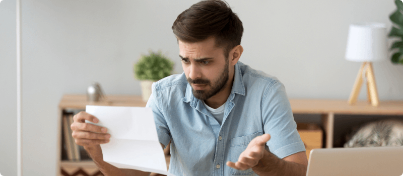 A worried person reviewing a document.