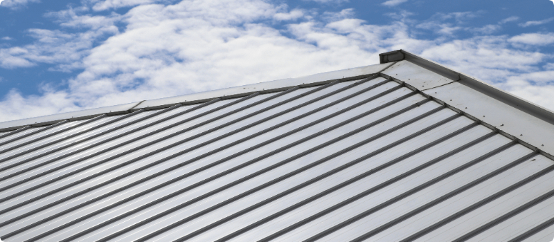 A close-up of a metal roof on a sunny day.
