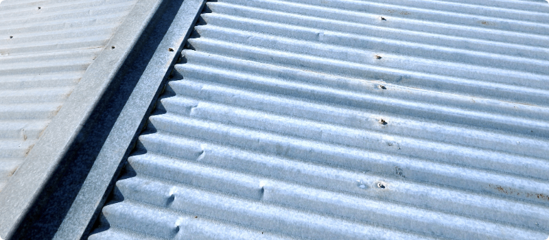 A slightly worn metal roof.