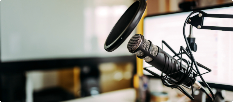 A home recording studio with a microphone and computer.