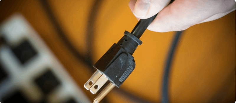 Hand holding a plug.