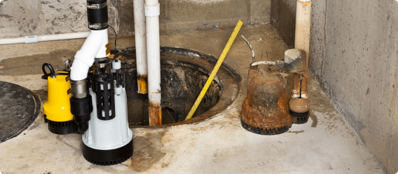 Old sump pump being replaced by a new one.