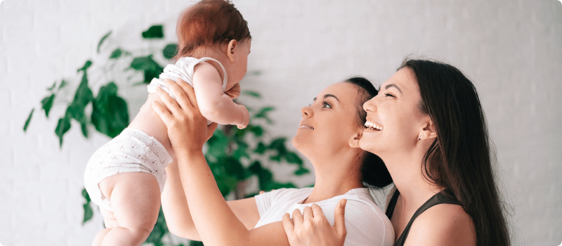 New parents playing with their baby.