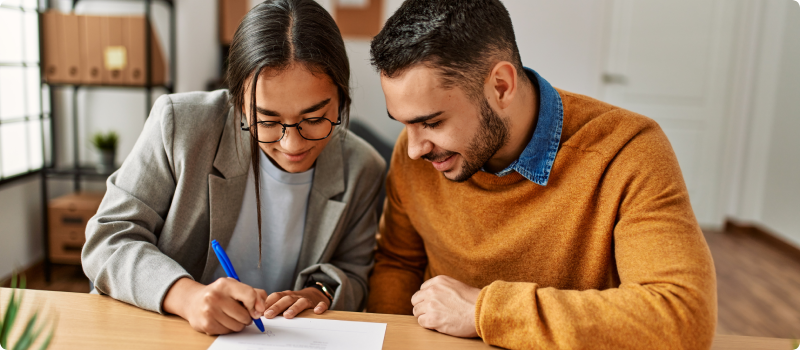 a couple signing a document
