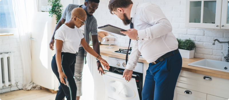Couple inspecting apartment with a property manager