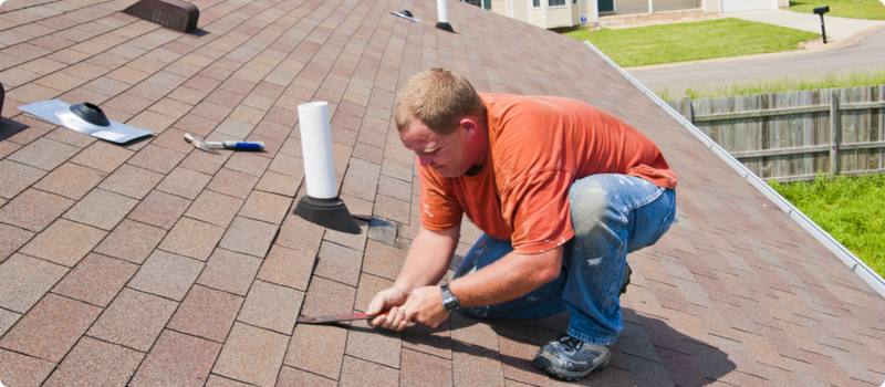 a man making repairs to a roof