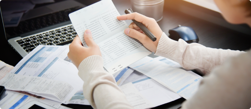 a person reading documents on their desk