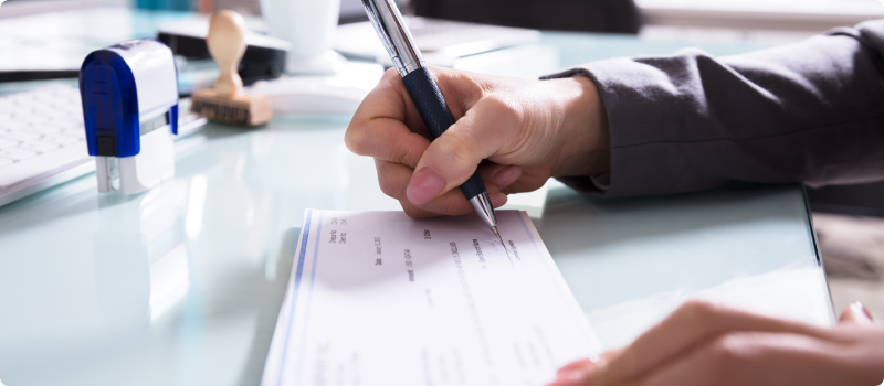 a person signing a check