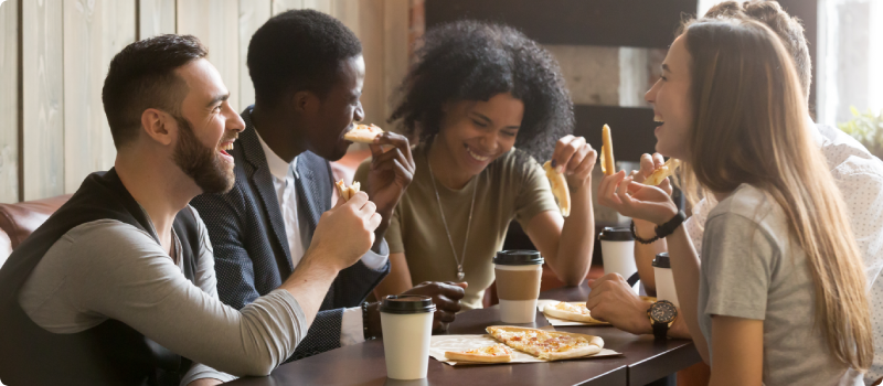 Friends eating pizza together