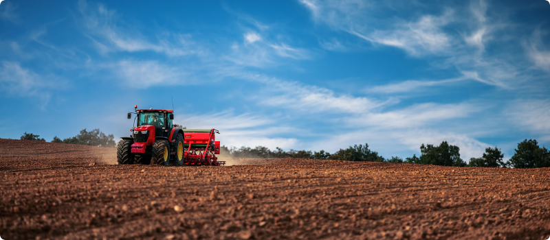 Farmer in tractor preparing farmland with seedbed for the next year.