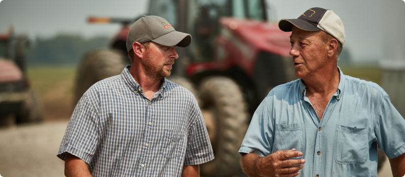 Men walking together on farm land