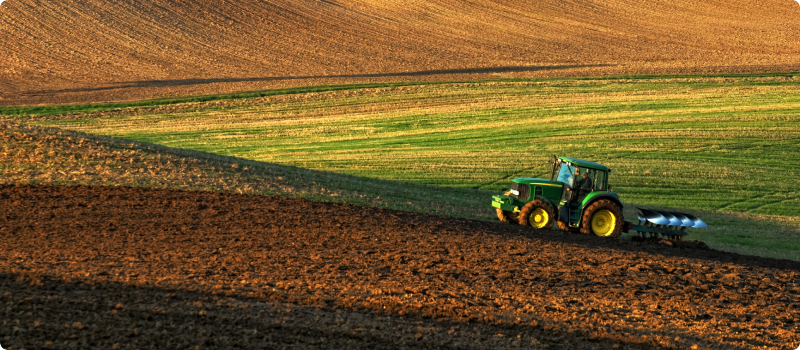 Tractor plowing field