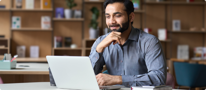 Indian man working on a laptop