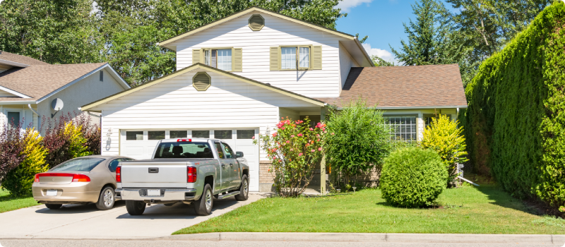 Single family home with two cars parked in the driveway