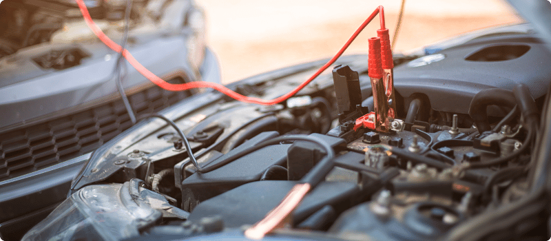 jumper cables on a car battery