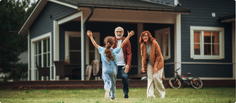 Grandparents meeting granddaughter in front of their house