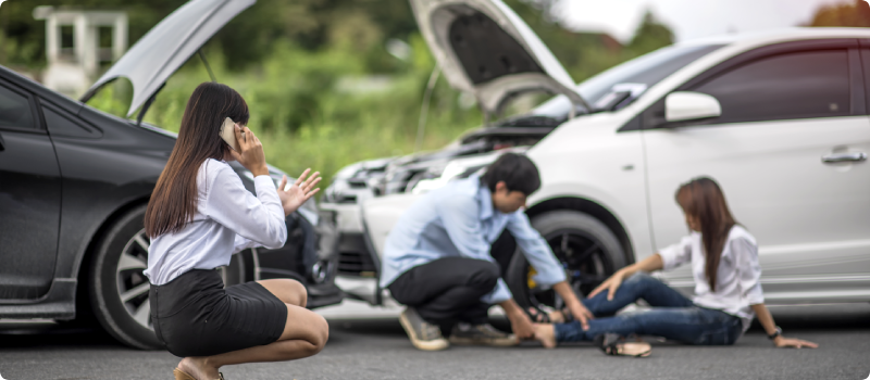 a man tending to an injured woman after a car accident