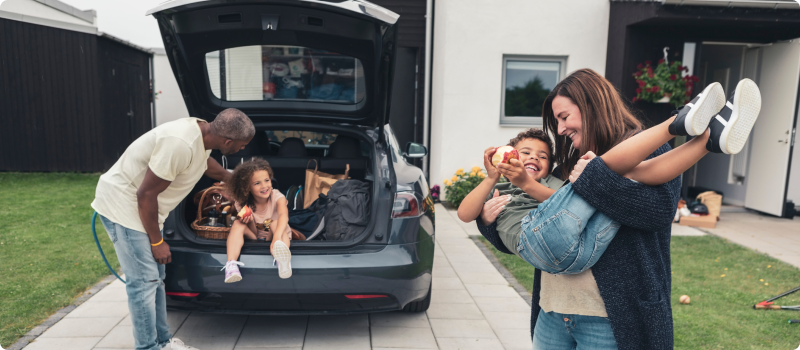 Parents with their children in the front yard