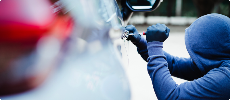 a thief breaking into a car