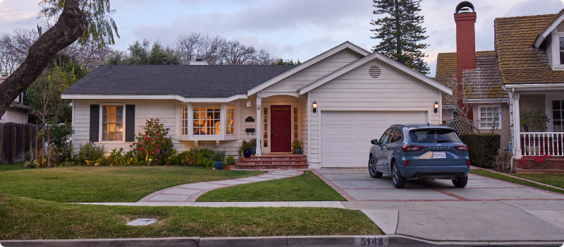 A single house with a parked car in the driveway