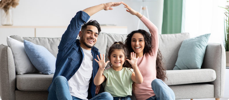 a man, woman and child in their home