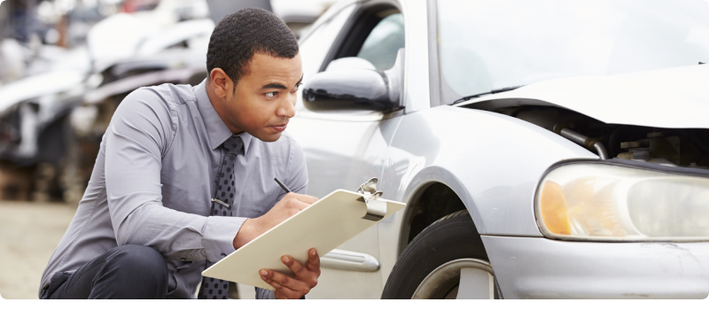 Insurance adjuster taking notes on a clipboard