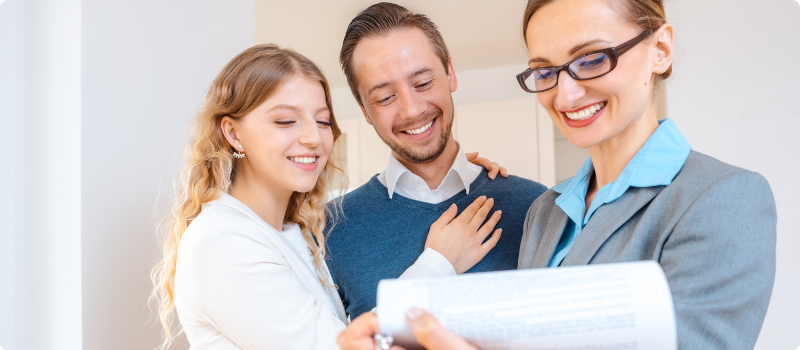 a couple looking at paperwork with landlord