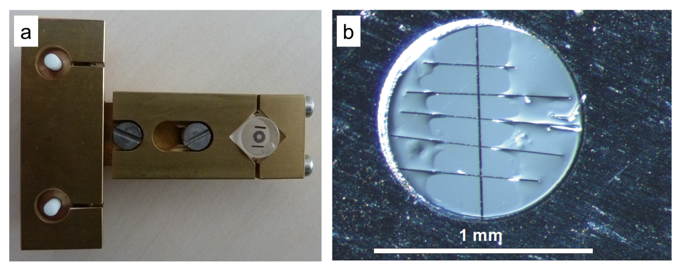 a) Photography of the T-Tool developed at HMI/HZB, with a glass cylinder attached to it, on top of which the specimen is clued by use of hot wax. b) Light micrograph of the inner part of a Mo support ring, showing the interface region (black vertical line in the middle of the image) with the glass substrates of the thin-film stacks on either side, as well as carbon fibers glued across the interface region of the cross-section.