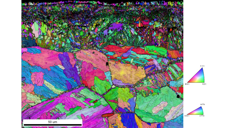 The EBSD IQ and IPF orientation map (relative to the surface normal direction) shows that the veins of Fe-N phases are extending through the boundaries between prior austenite grain boundaries.