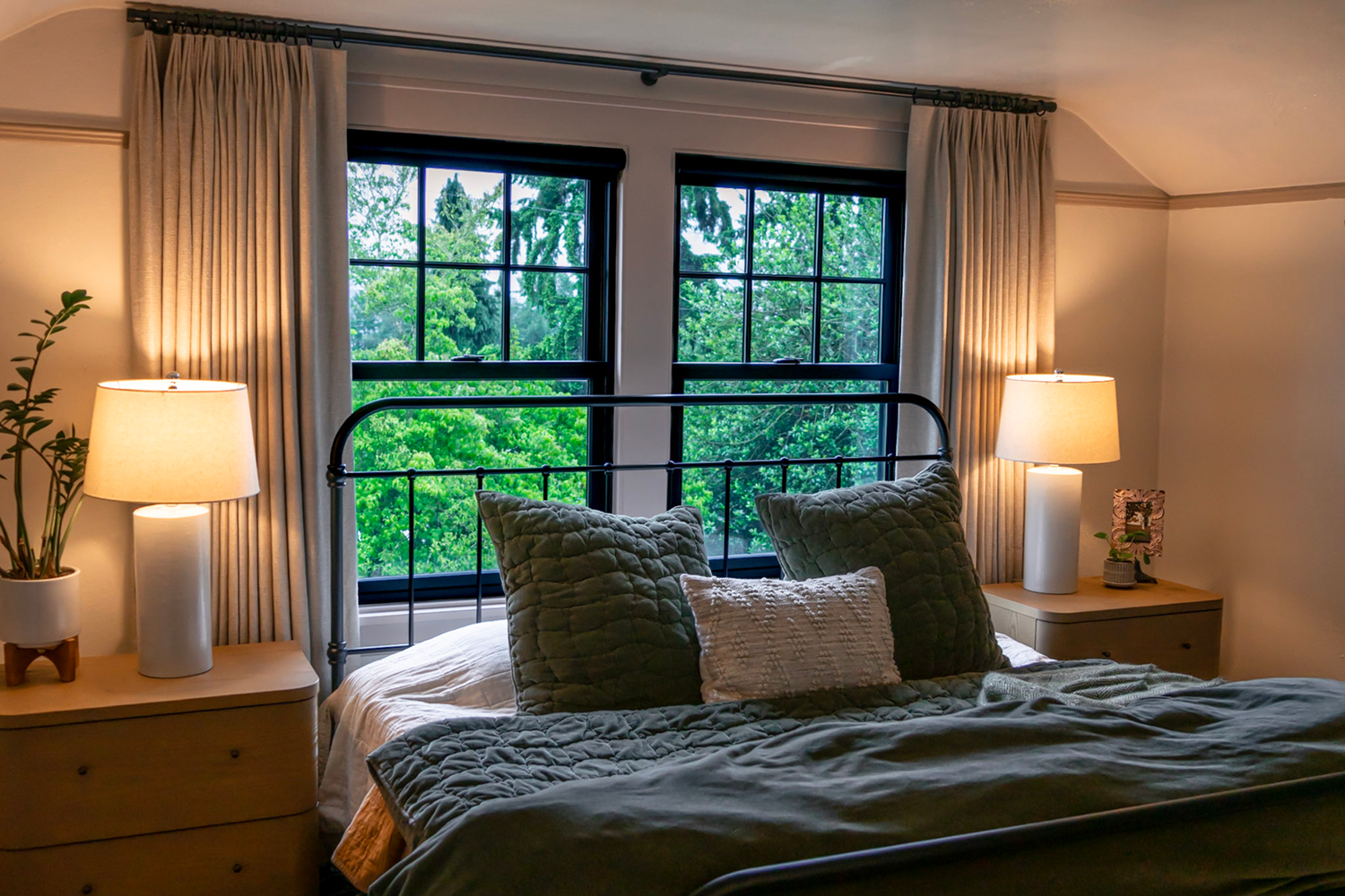 A bedroom with two double hung windows that bring light to life