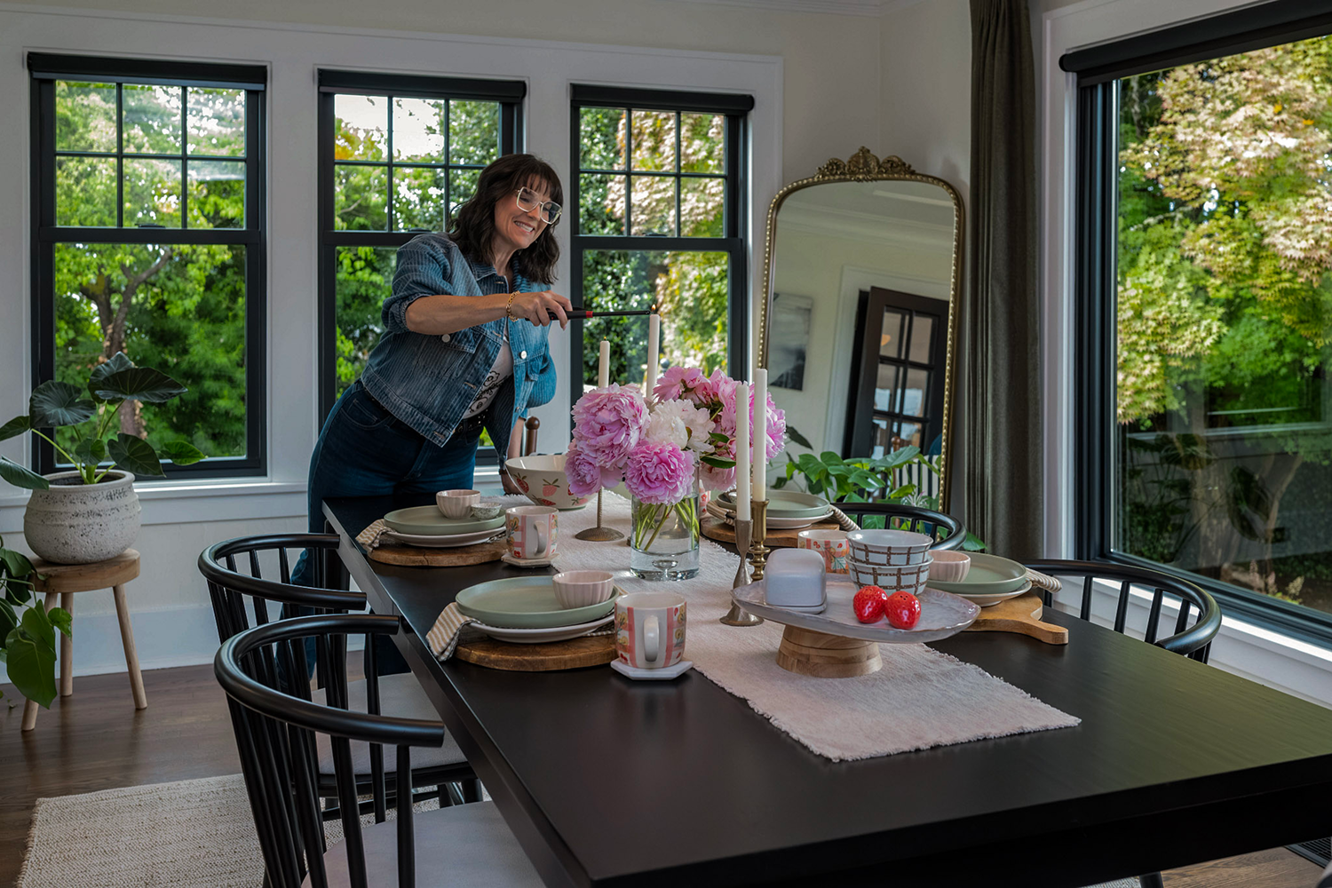 A dining room with Black Renewal by Andersen windows, there is so much light coming into the room